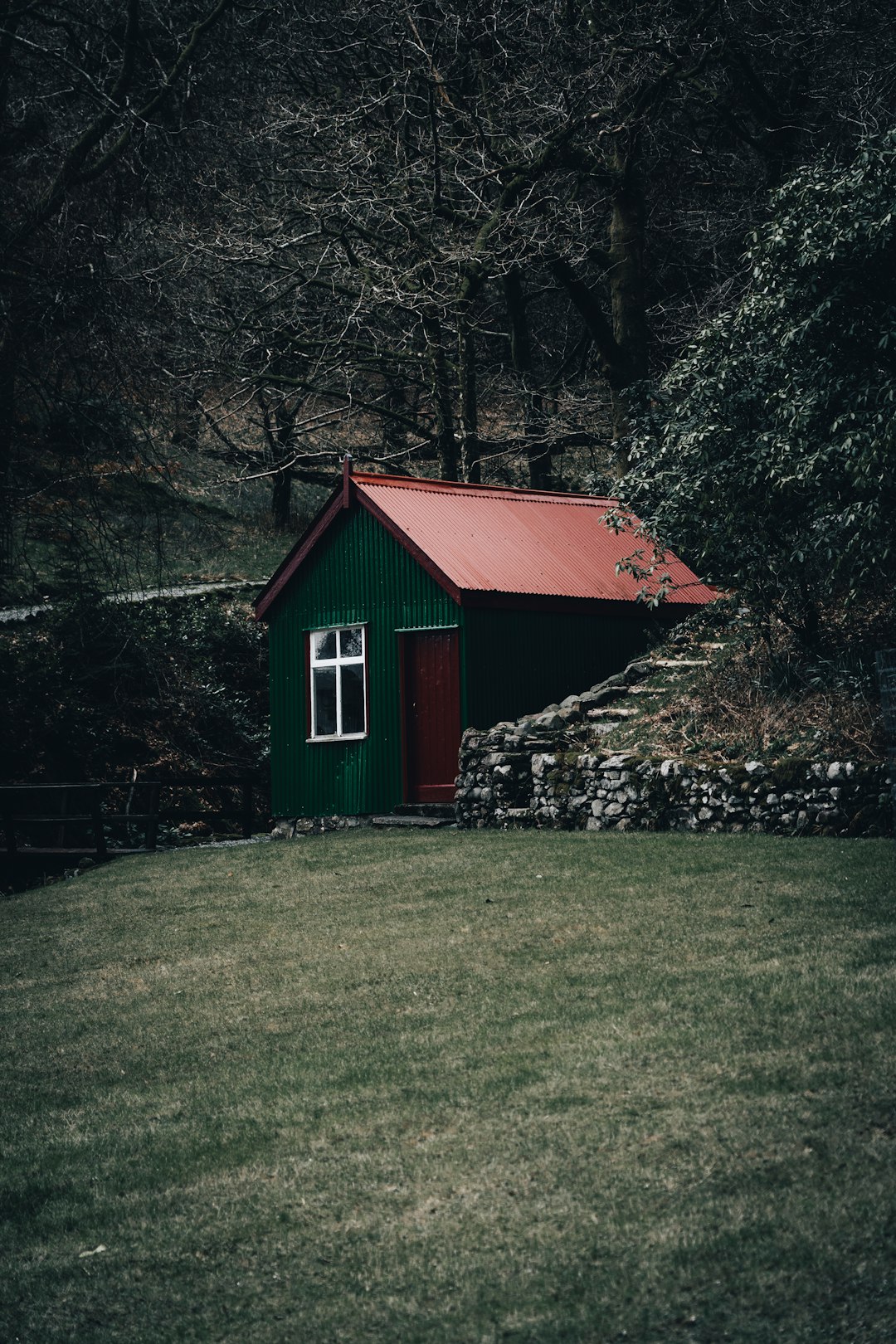 red and white wooden house near green trees during daytime