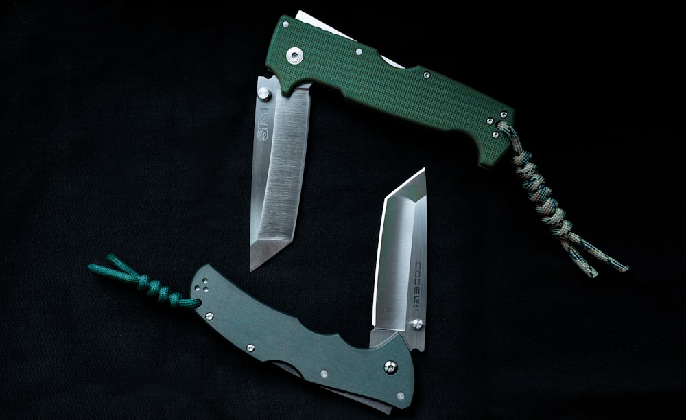 green and silver folding knife