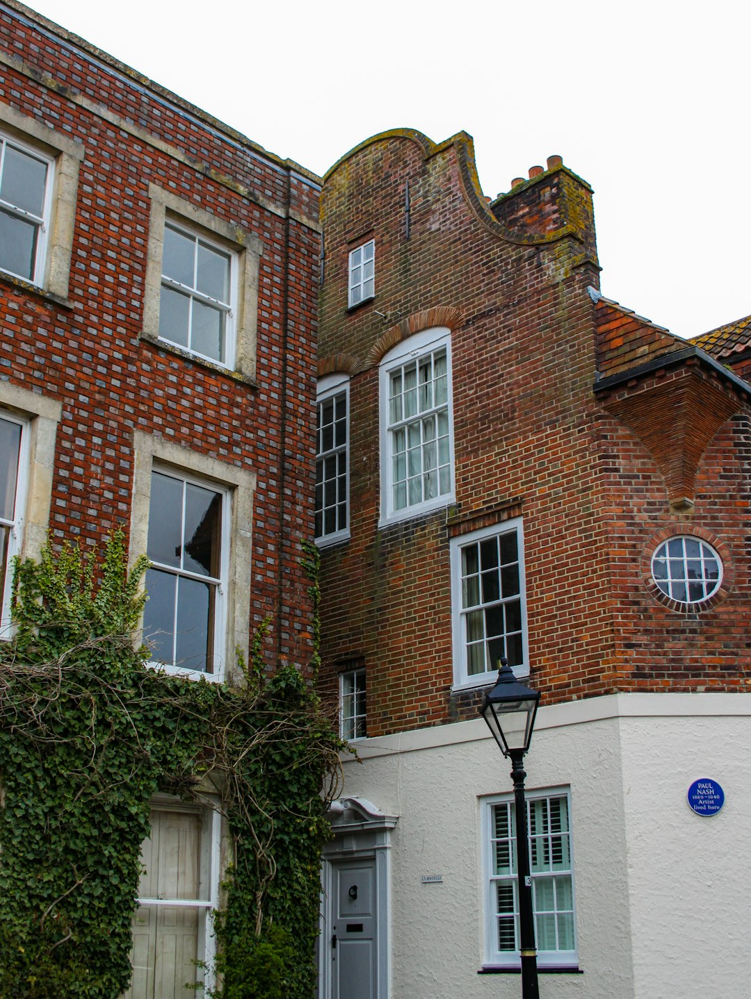 brown brick building with green tree in front