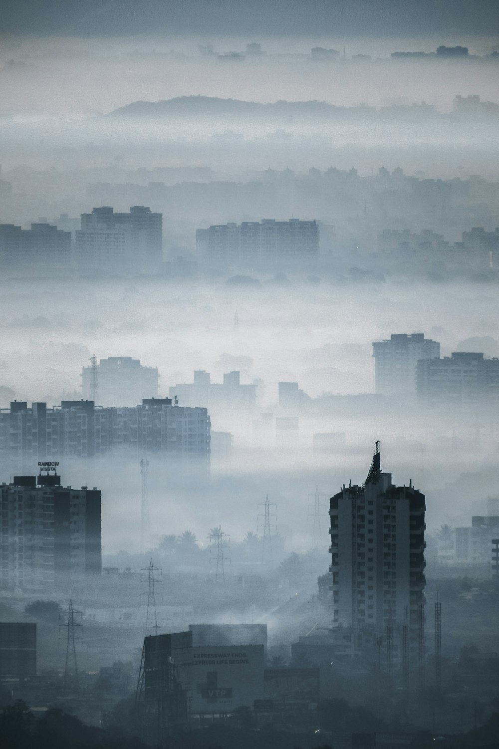 high rise buildings under white clouds during daytime