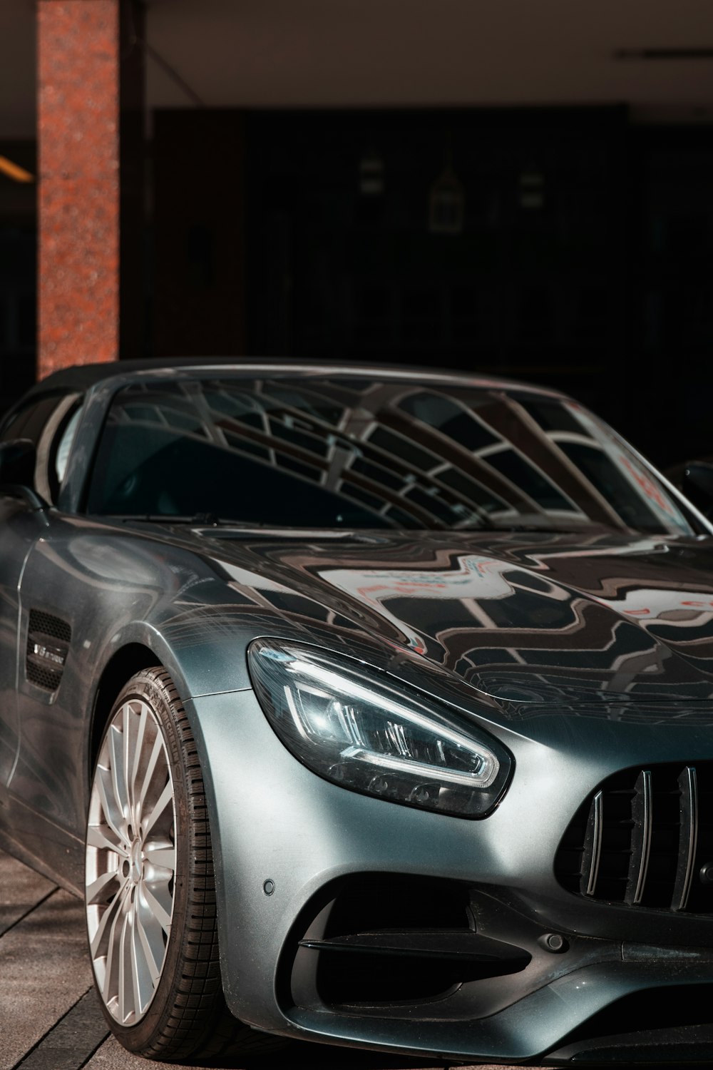 silver mercedes benz coupe parked near brown concrete building during daytime