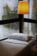 white bed linen near white window curtain