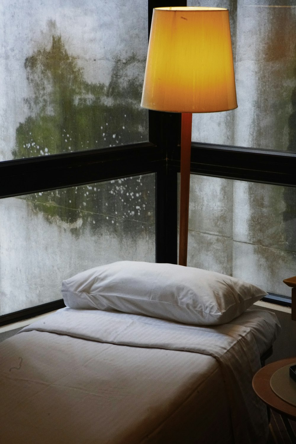 white bed linen near white window curtain