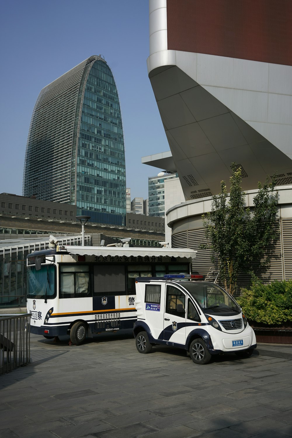 white and blue bus on road near building during daytime