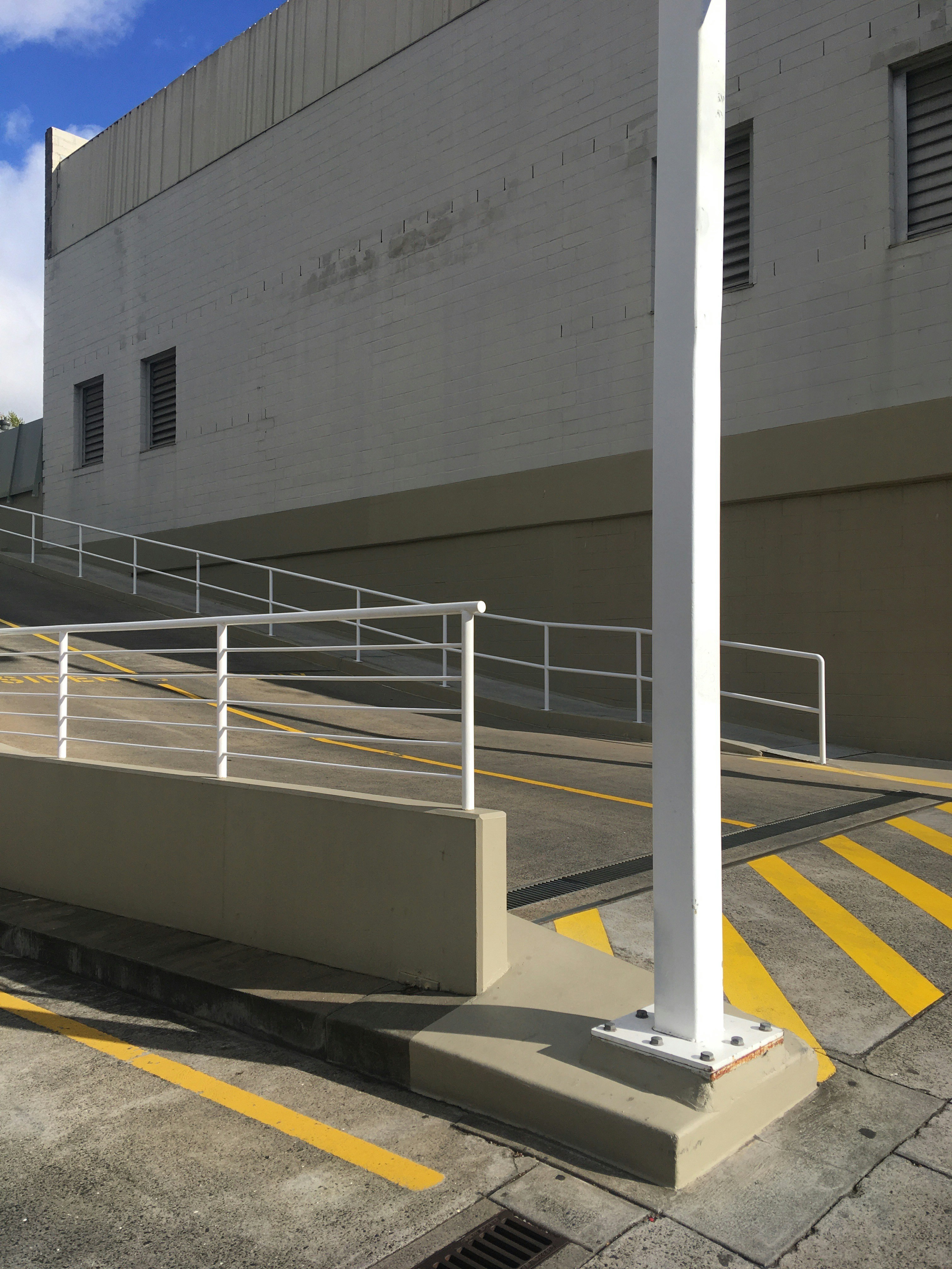 white metal railings near white concrete building during daytime