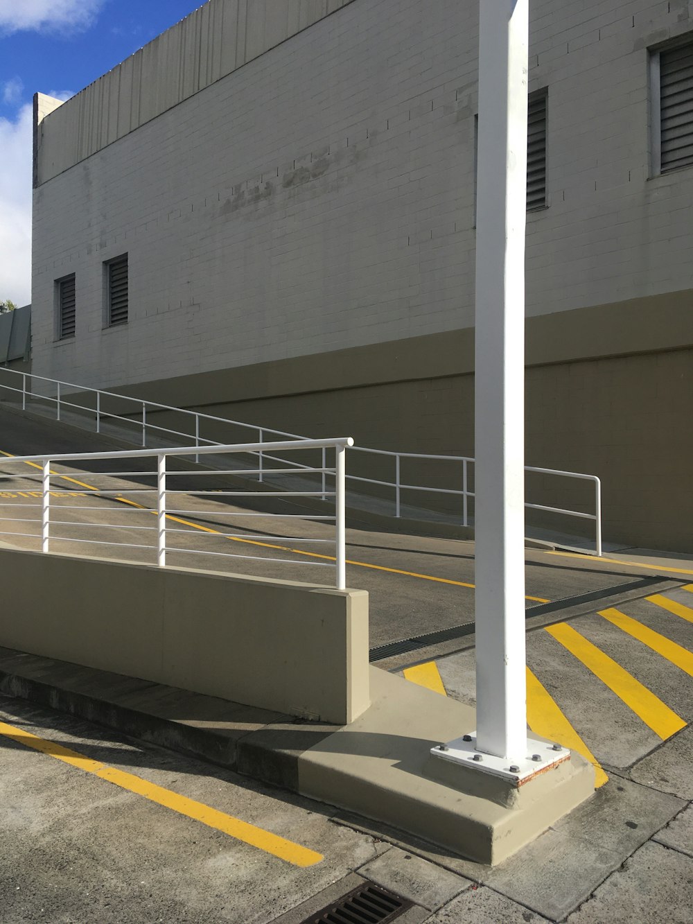 white metal railings near white concrete building during daytime