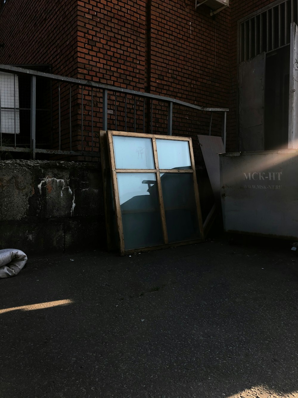 white wooden door near brown brick wall