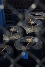 Stack of grader and tractor tires ready for shipment in warehouse.