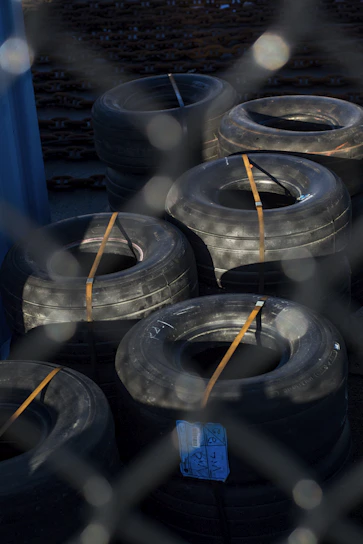 Stack of durable truck tires ready for installation in a warehouse setting