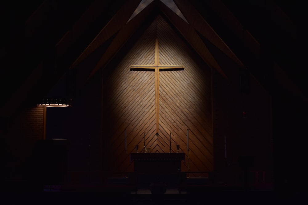 brown wooden cross on brown wooden wall