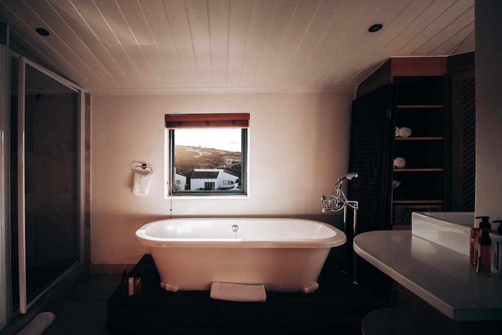 white ceramic bathtub with stainless steel faucet