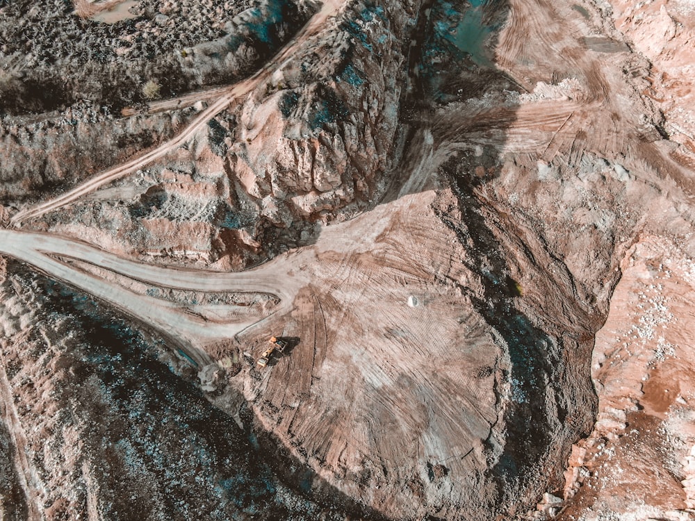 aerial view of road between brown mountains during daytime