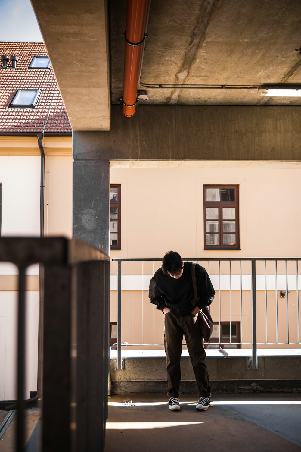 man in black jacket and black pants standing on hallway