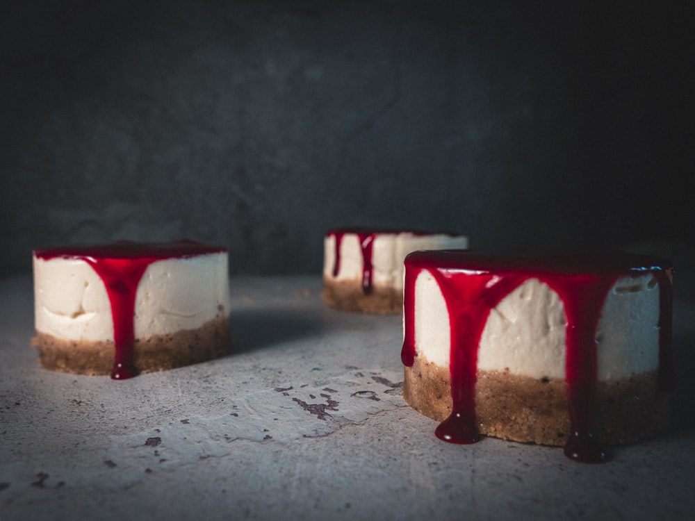 2 red and white candles on white surface