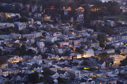Street-level perspective highlighting a vibrant urban neighborhood with mixed-use multifamily buildings.