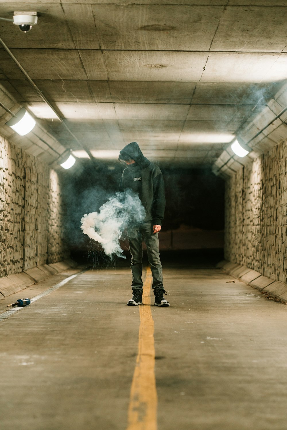 man in black jacket and black pants holding white smoke