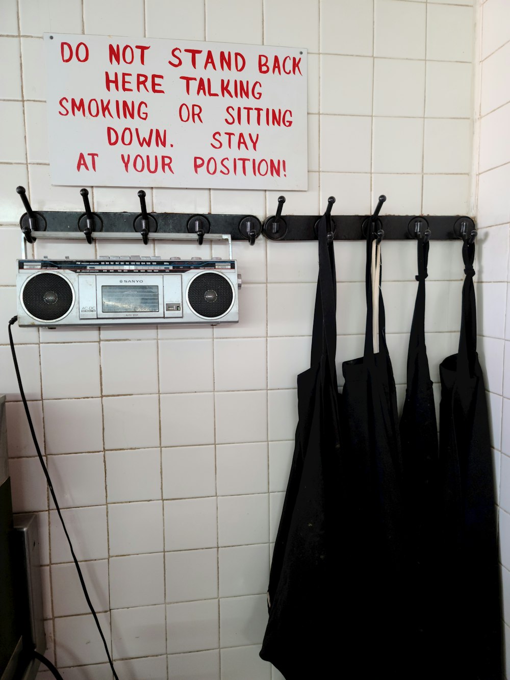 black and silver radio on white wall tiles