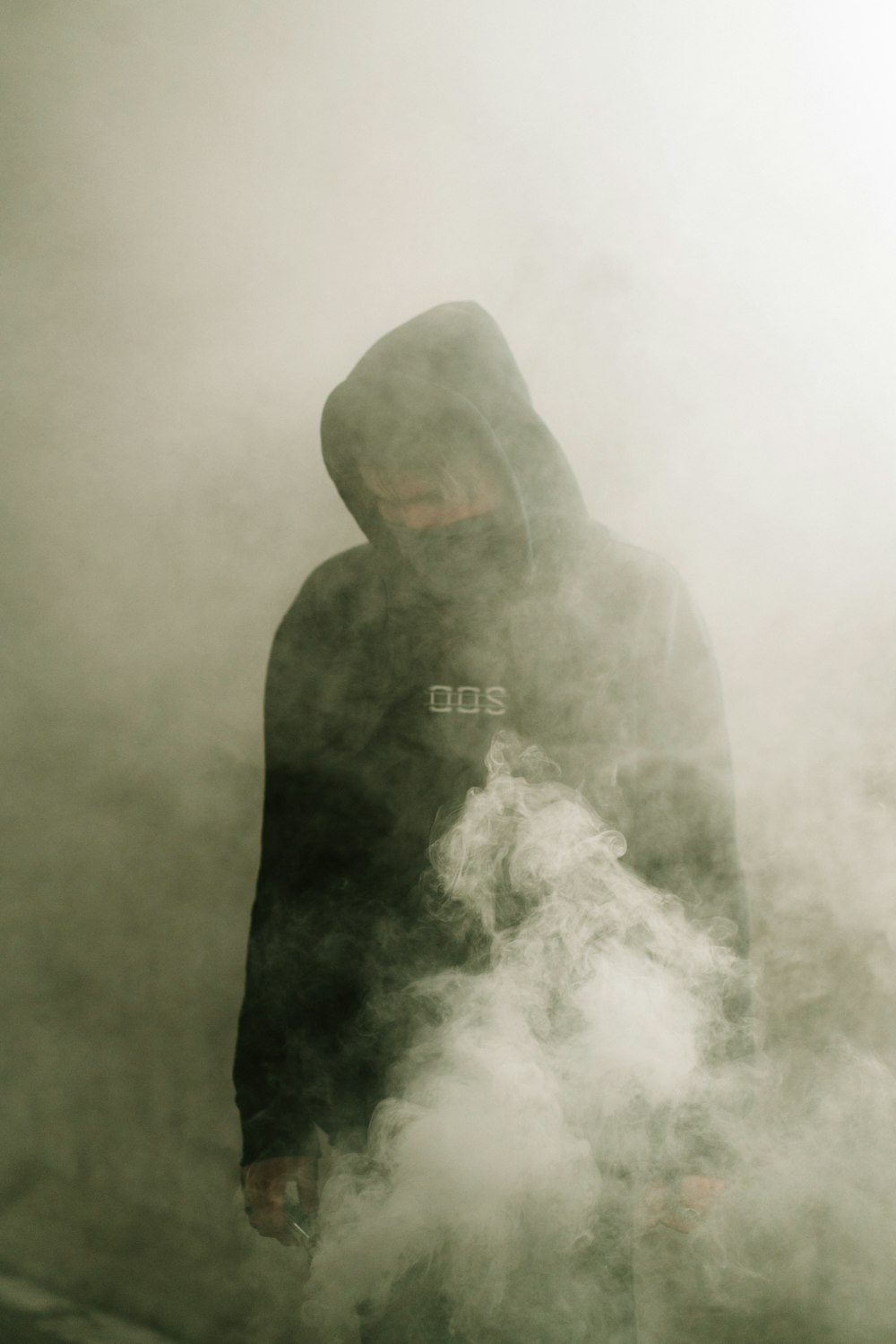 man in black hoodie with white smoke