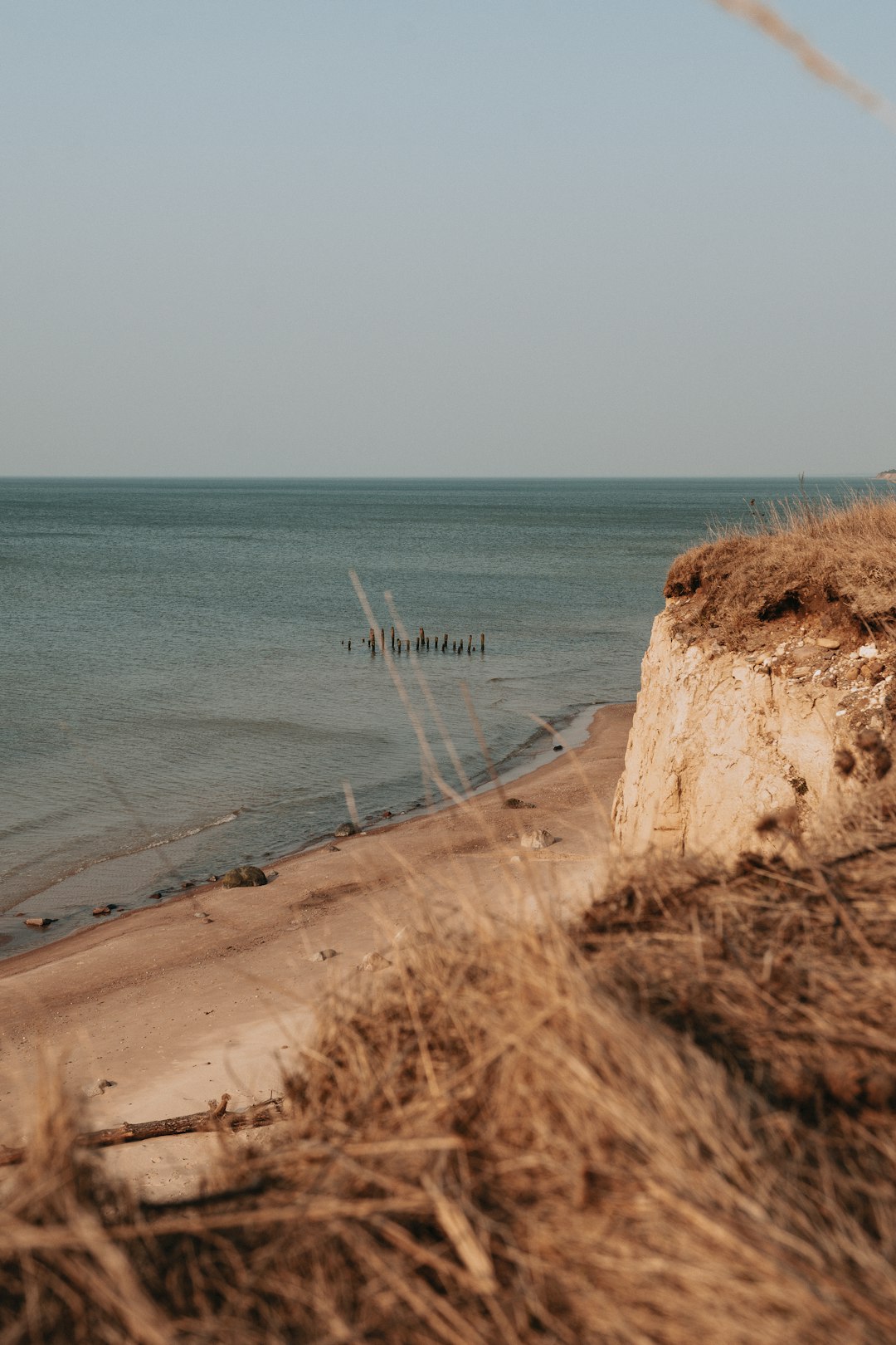 brown sand beach with white boat on the sea during daytime