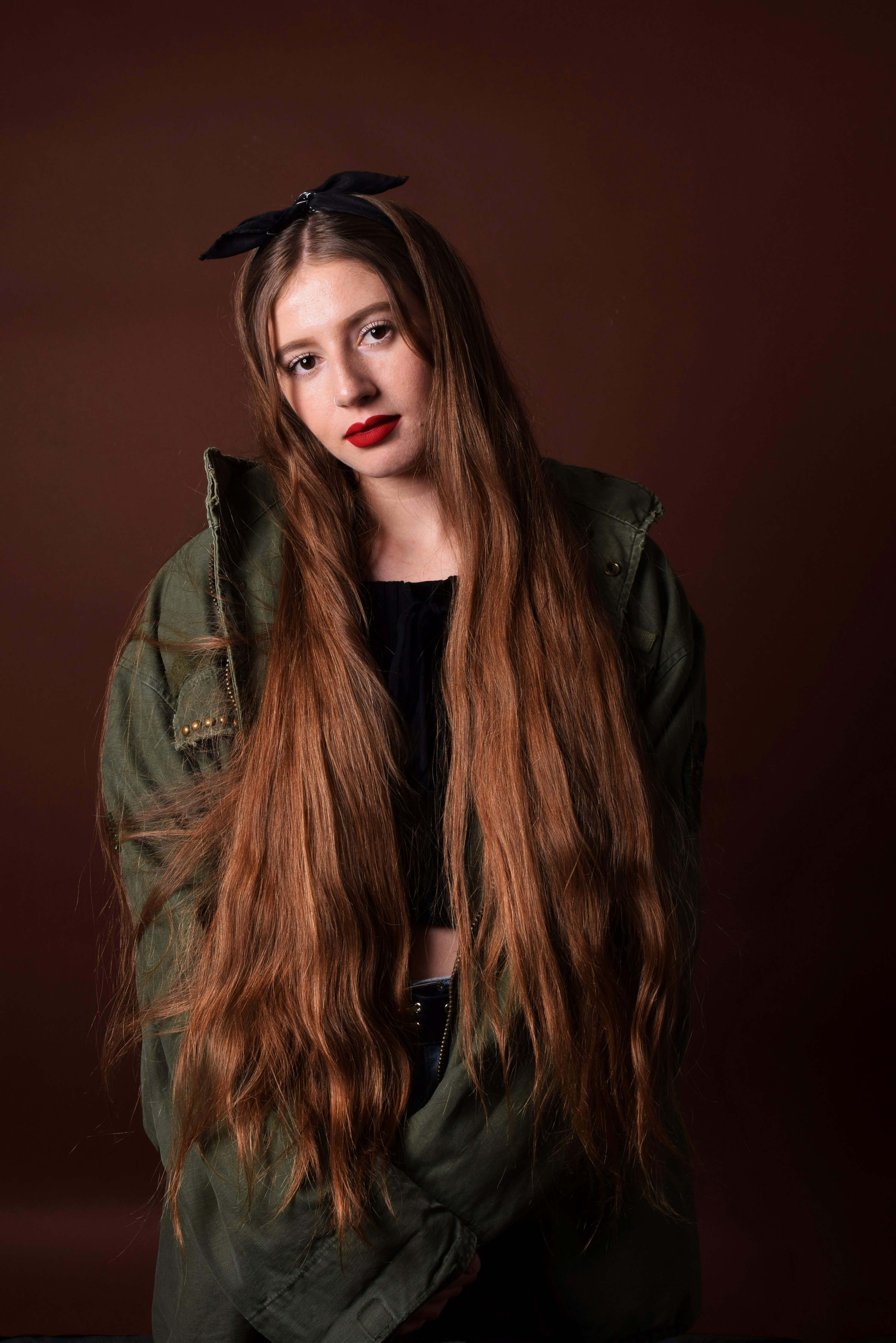 woman in green jacket and black shirt