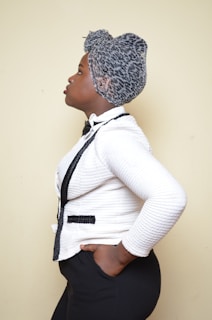 A stylish man wearing a custom-made afrocentric jacket with rich, earthy tones.