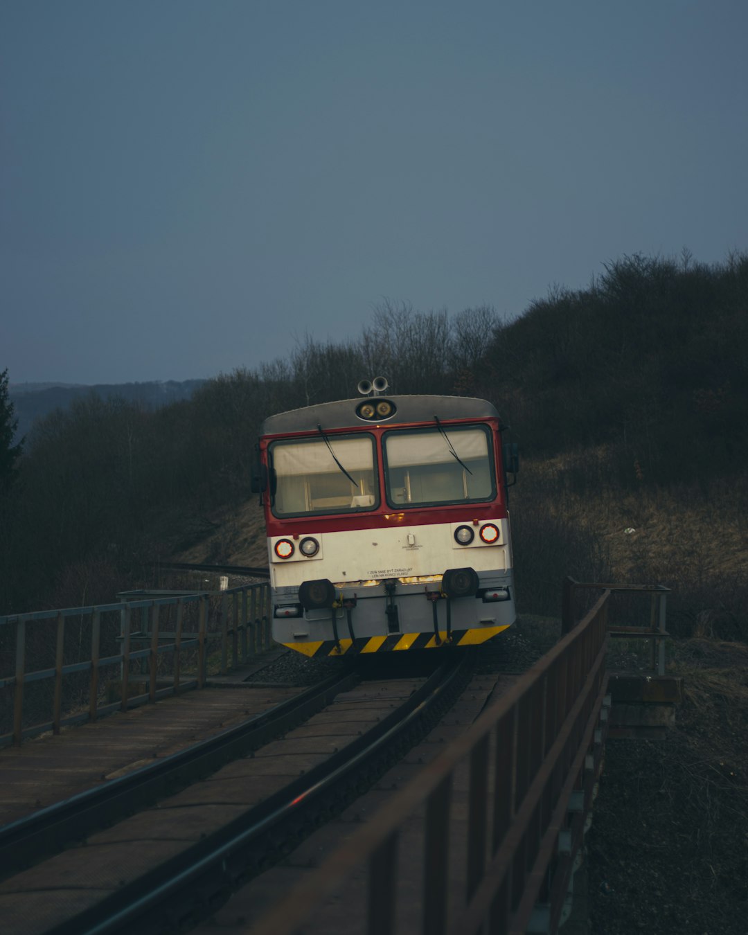 yellow and white train on rail tracks during night time