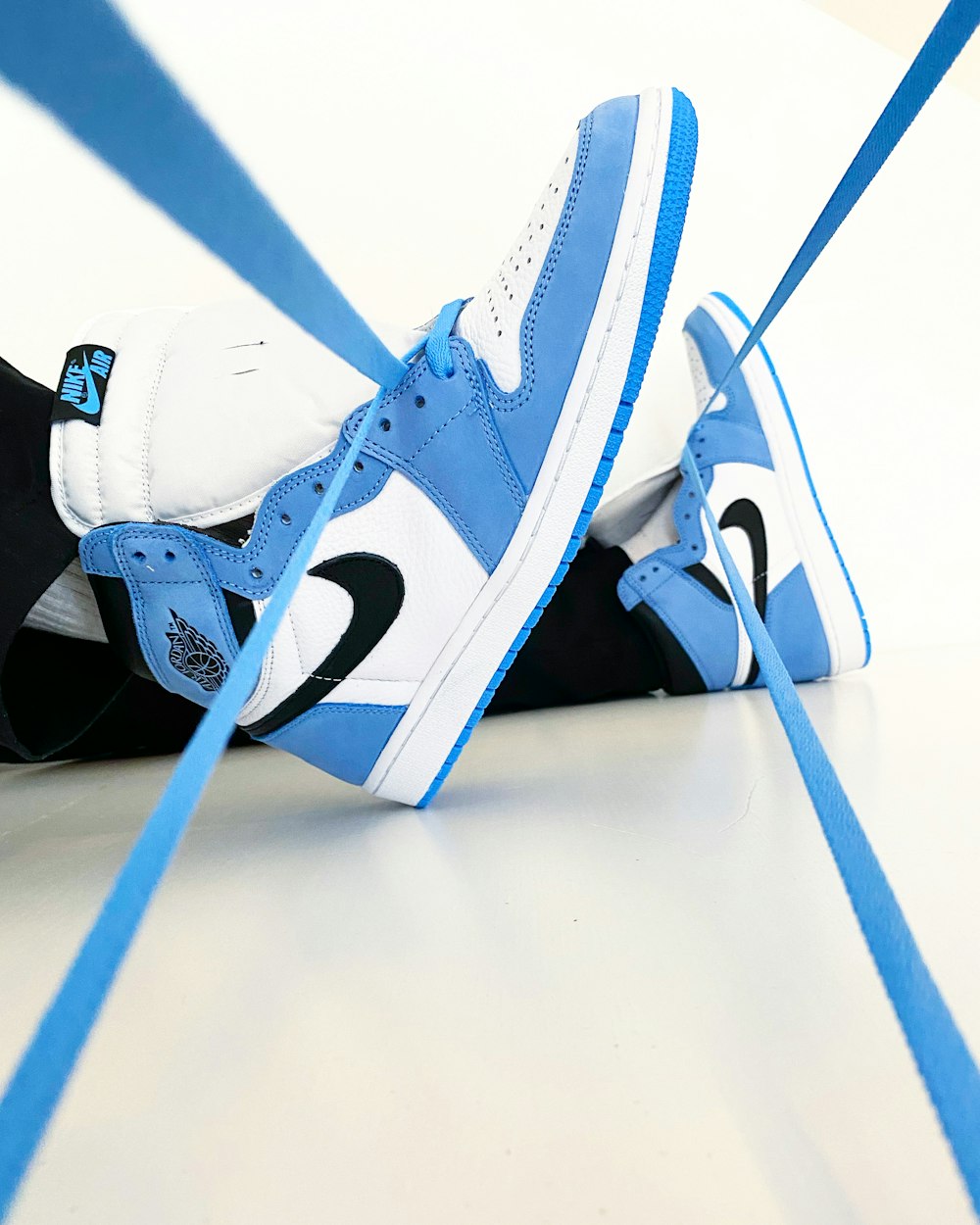 white blue and black nike high top sneakers