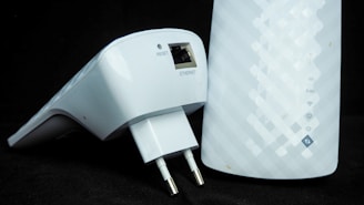 Hand unplugging a device from a wall socket to save electricity
