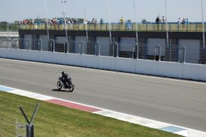 Rider on a racetrack with a coach filming for video analysis during a race track accompaniment