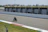A motorcyclist on a racetrack being filmed for video analysis during training.