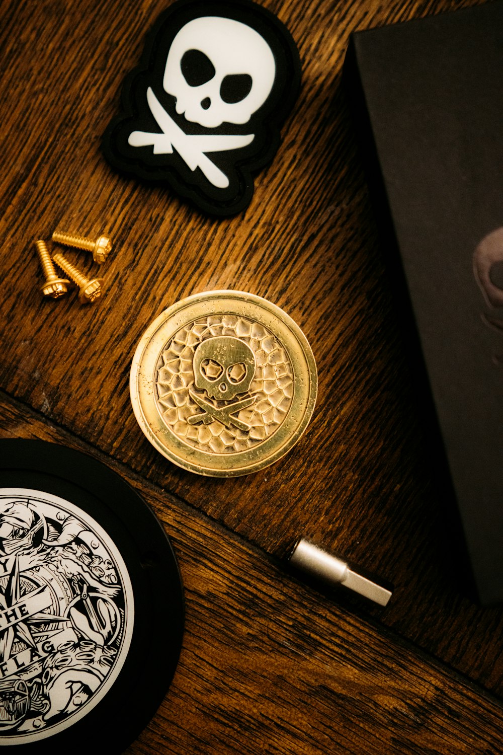 gold round coin beside white cigarette stick on brown wooden table