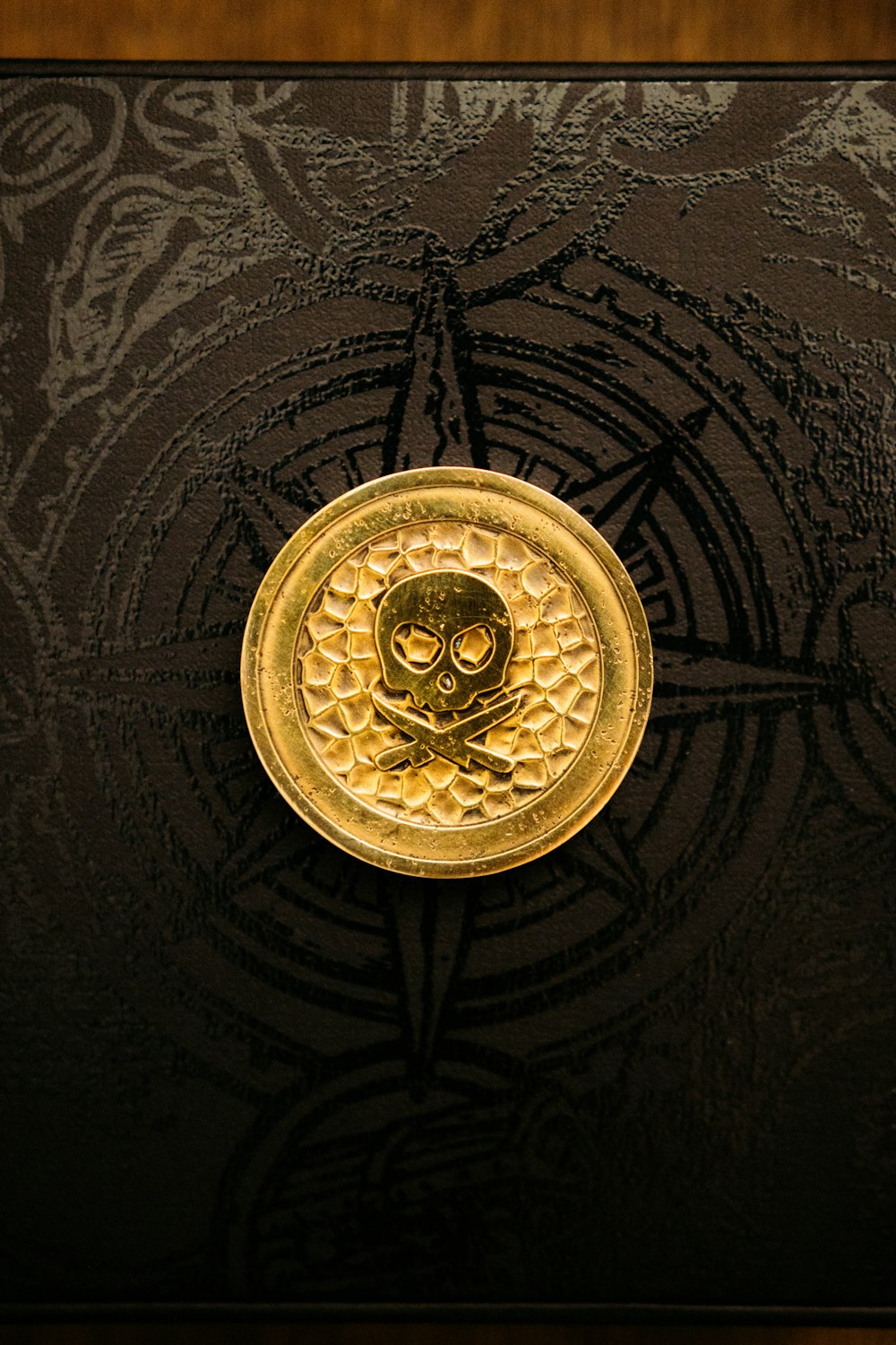 gold round pendant on black textile