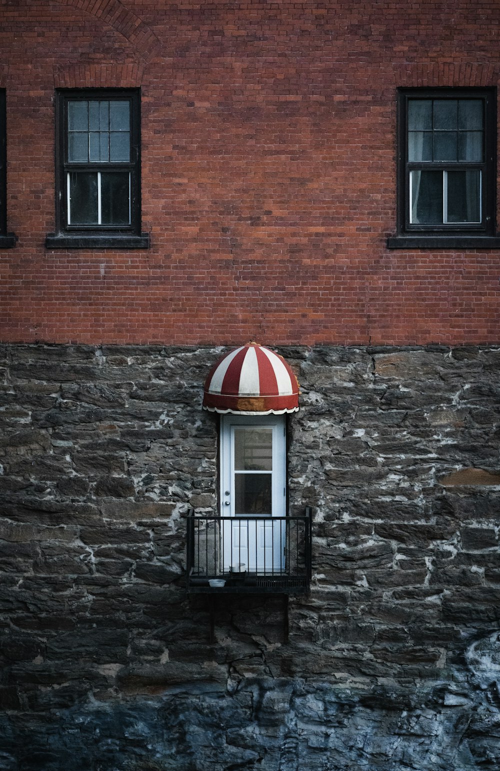 brown brick walled building with white framed window