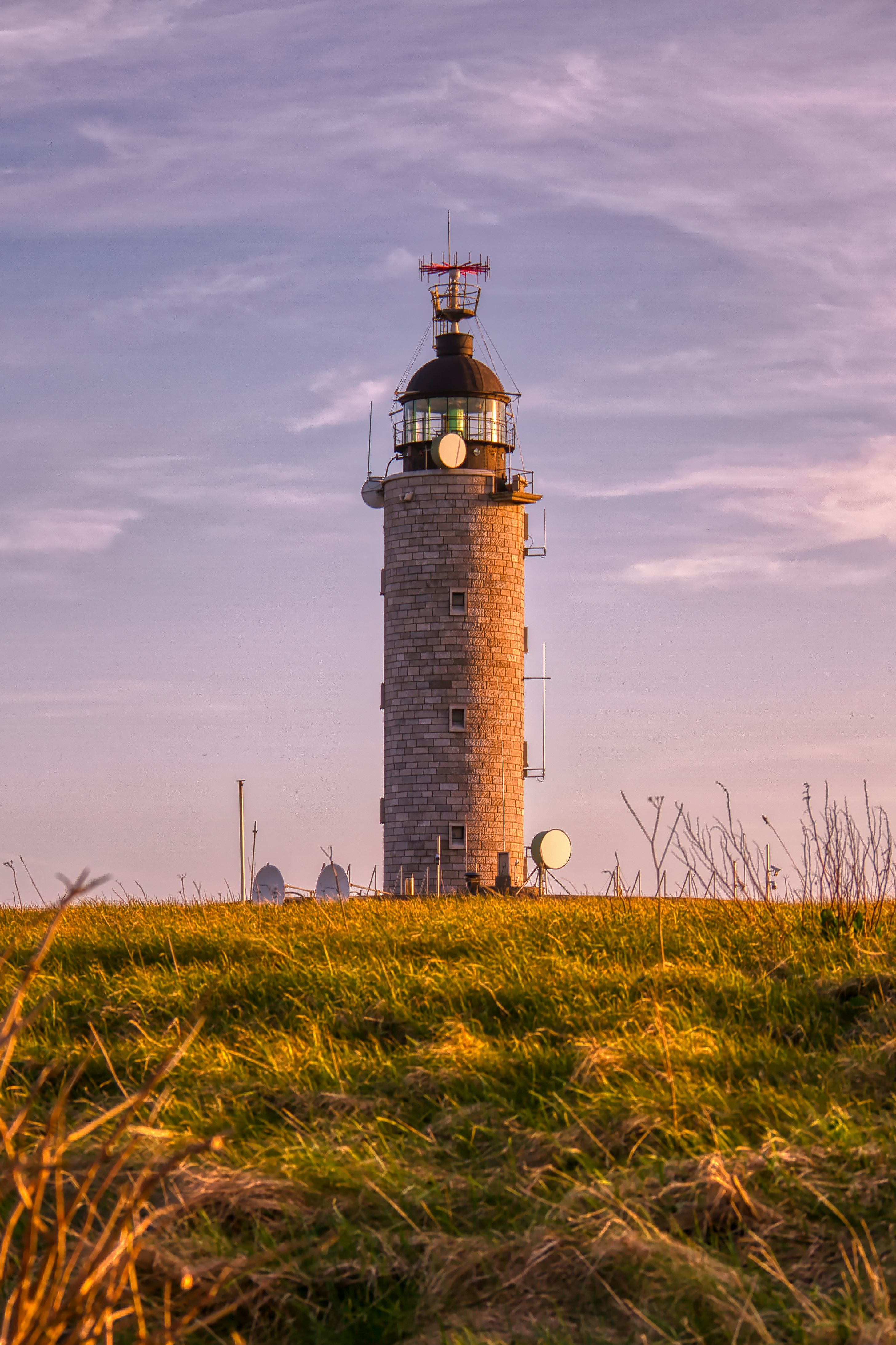 brown and white lighthouse under cloudy sky during daytime