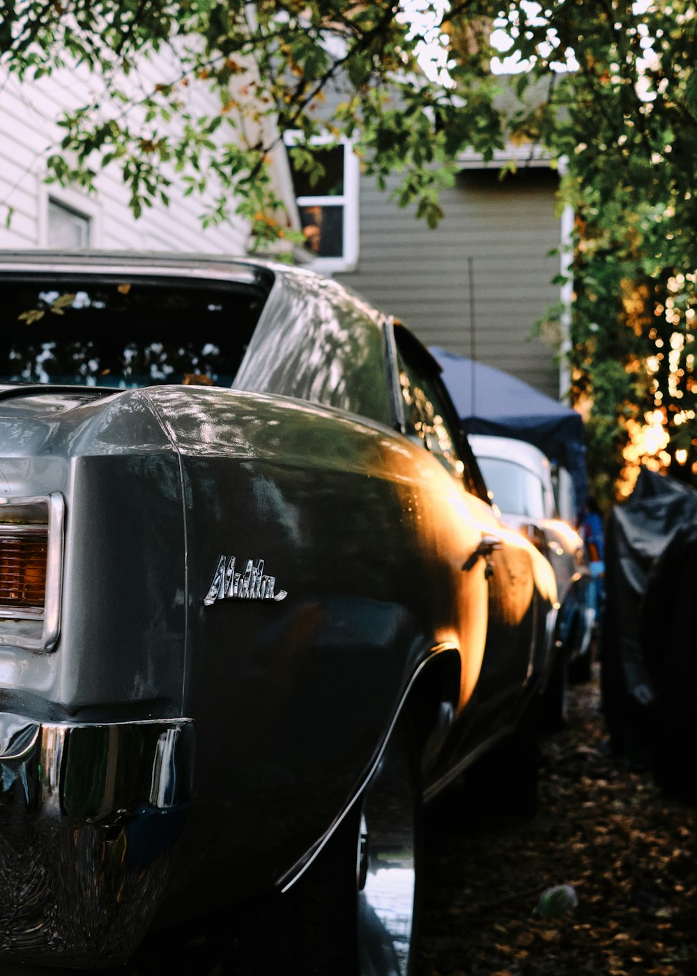 black car parked near white house