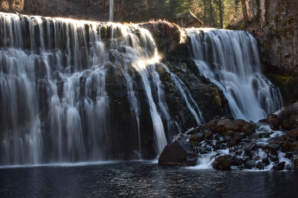 water falls on brown rocks