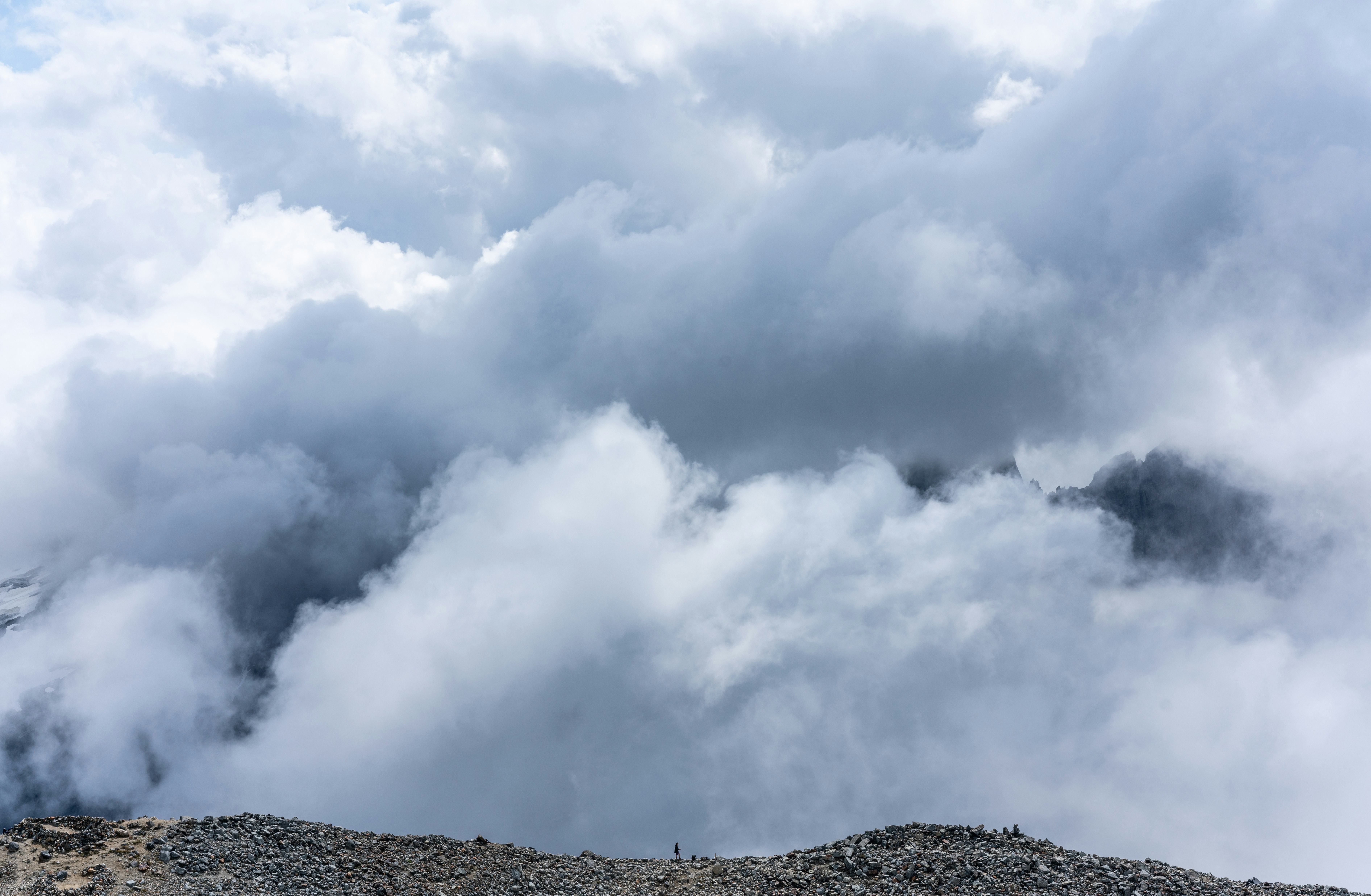 white clouds over green mountain