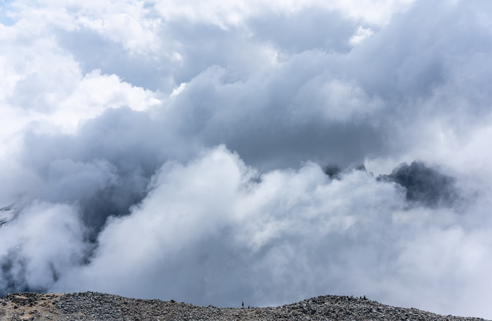 white clouds over green mountain