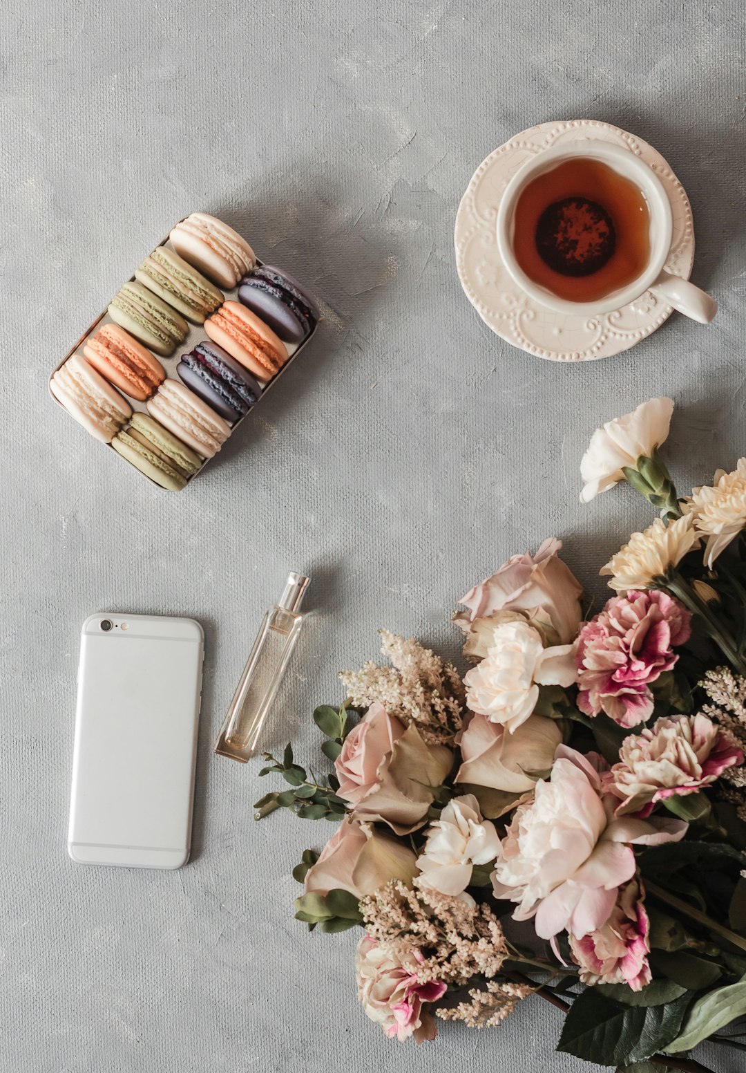 white ceramic mug beside white ceramic saucer on gray table