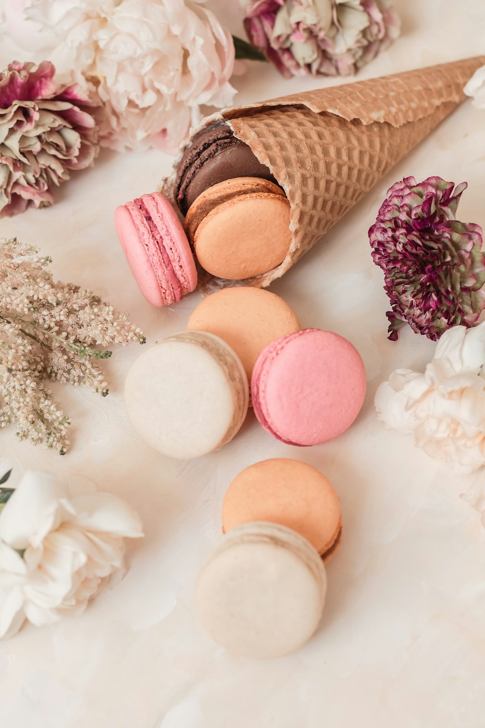 pink and white macaroons on white table