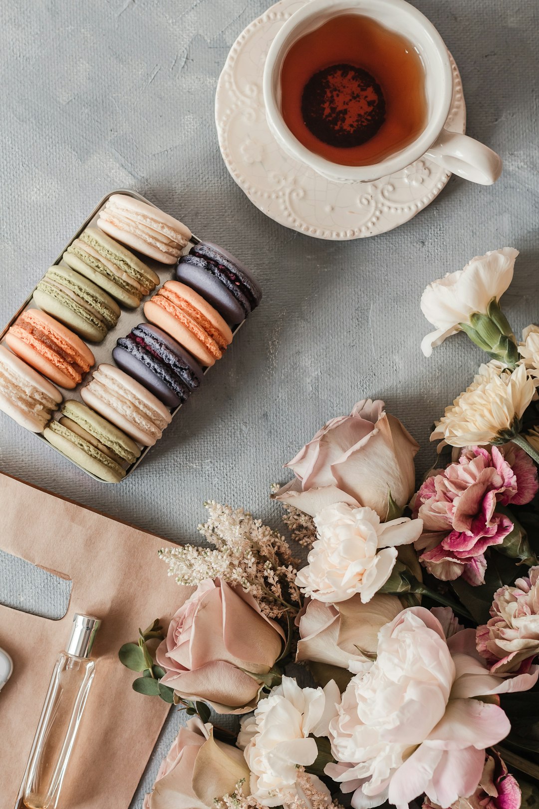 pink and white roses beside brown ceramic mug on table