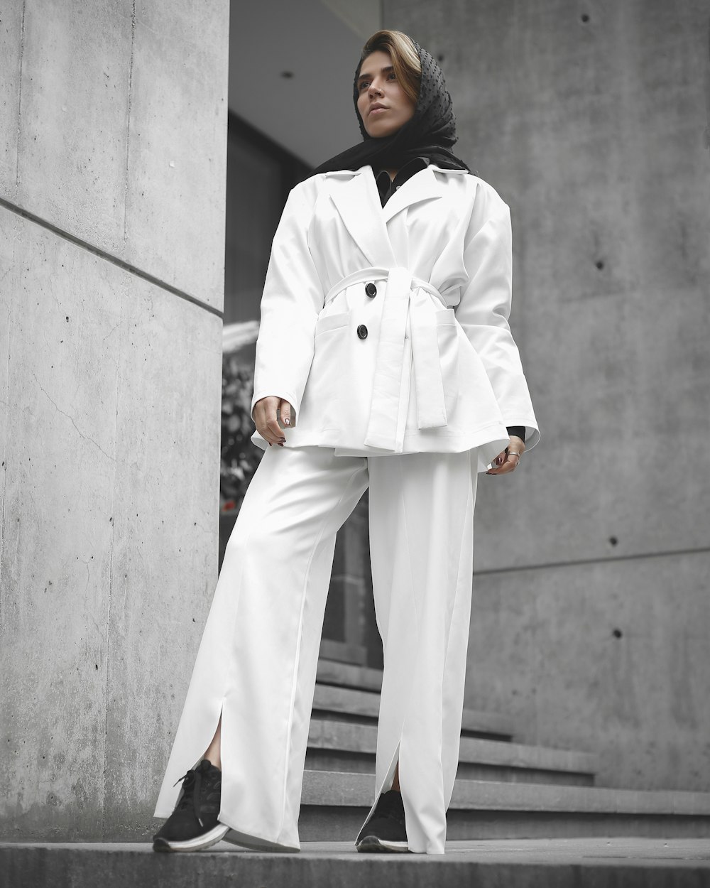 woman in white long sleeve dress standing beside white concrete wall during daytime