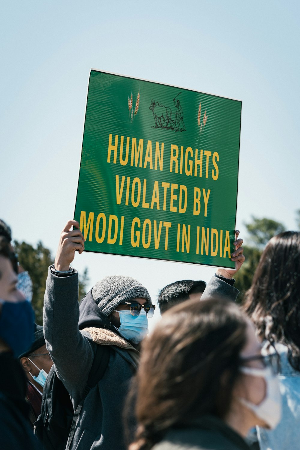 people holding green and black quote board during daytime