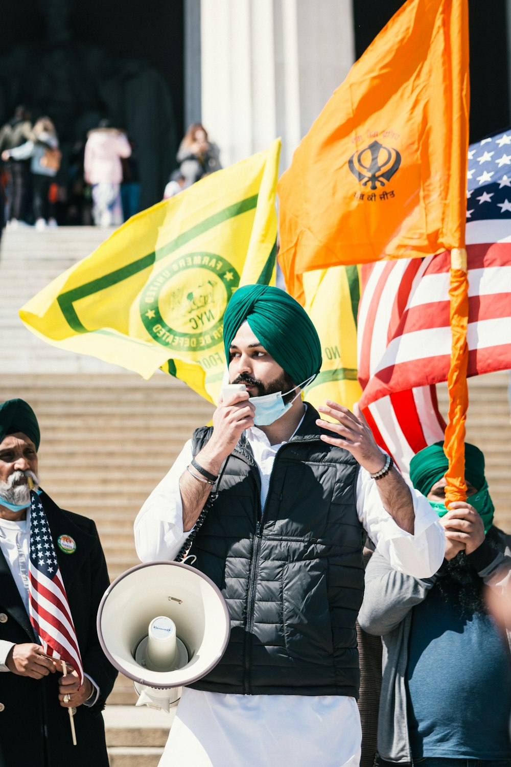 man in black leather jacket holding flag