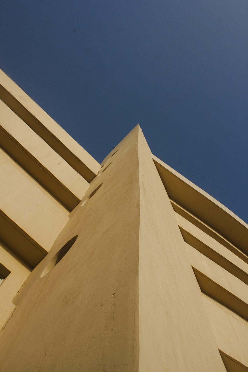 beige concrete building under blue sky during daytime