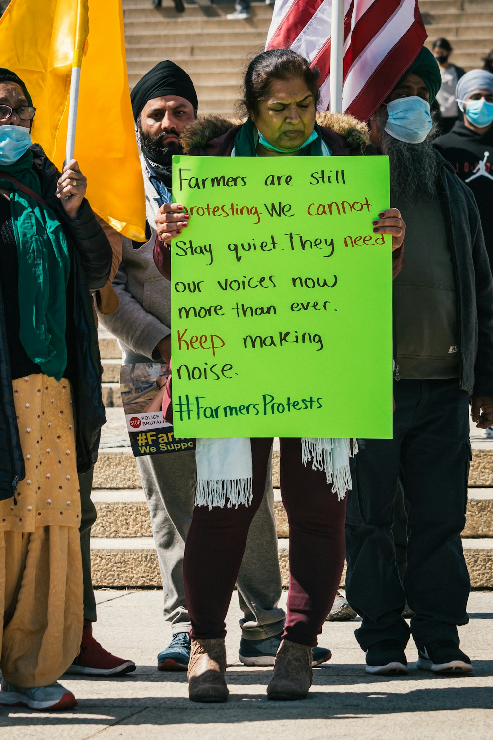 people holding green and yellow paper