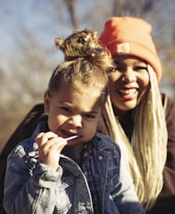 girl in blue denim jacket and orange knit cap
