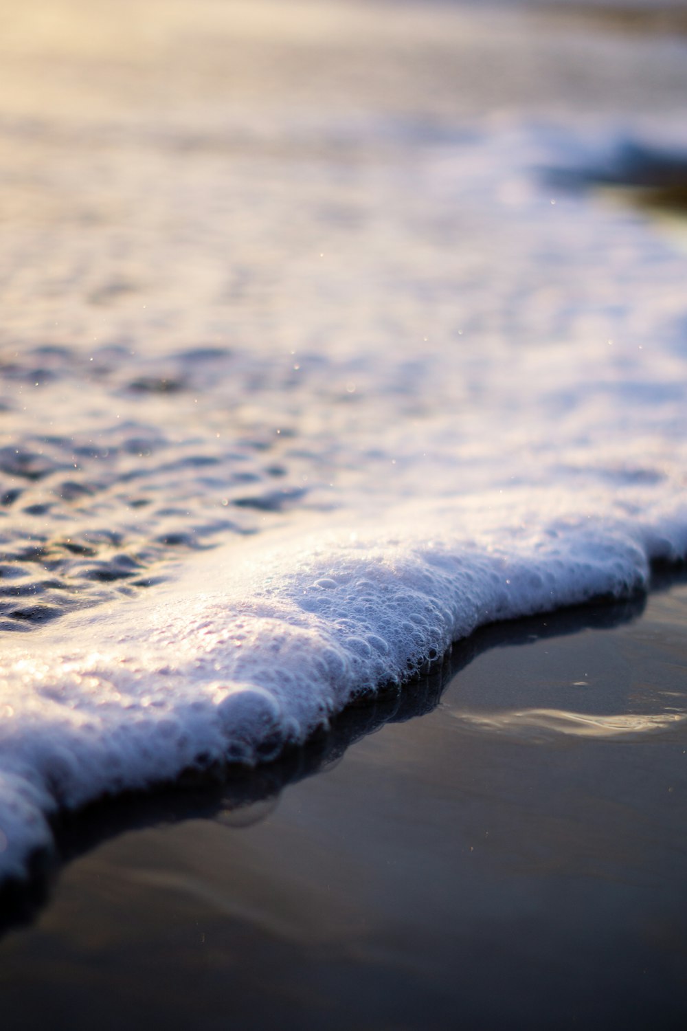 water waves on shore during daytime