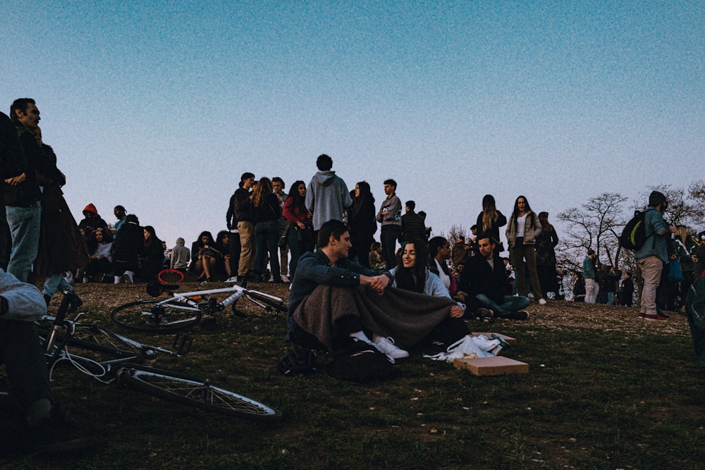 people sitting on grass field during daytime