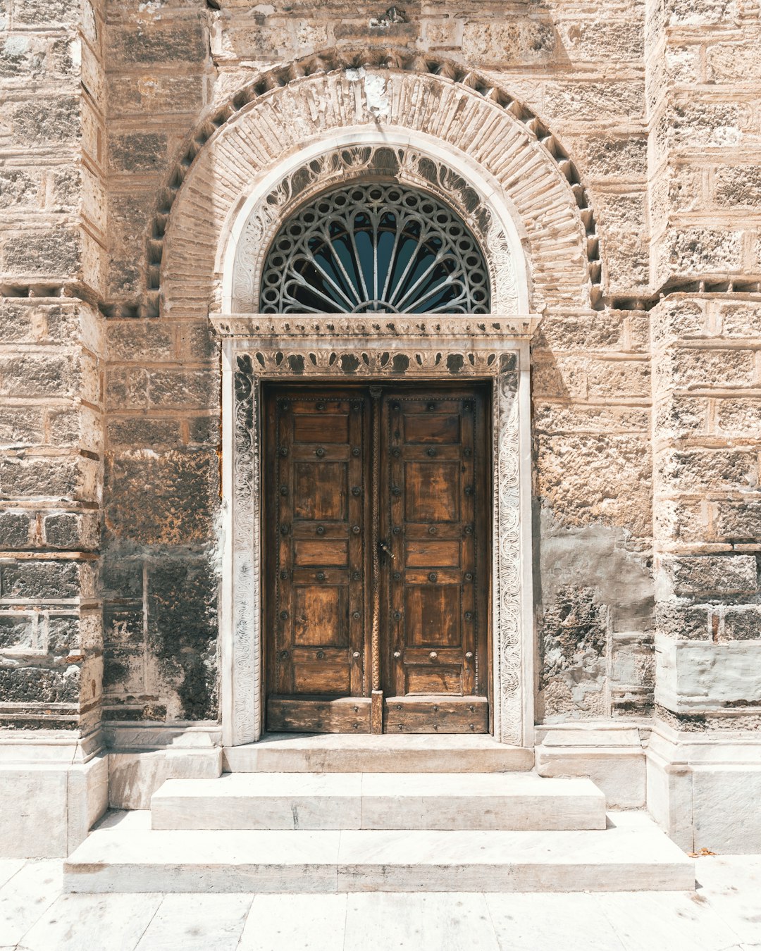 brown wooden door on gray concrete building